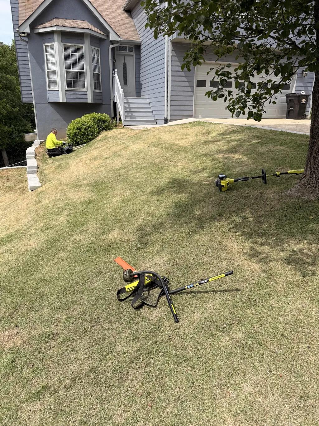 Lawn Expert Kid crew mowing and edging a residential front yard in Metro Atlanta